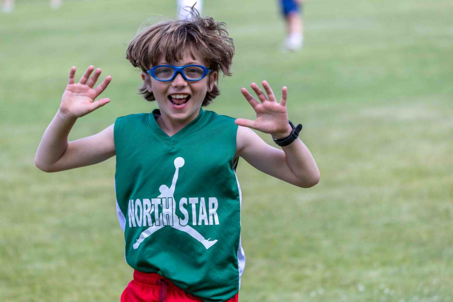 A camper laughing during a game at North Star Camp for Boys