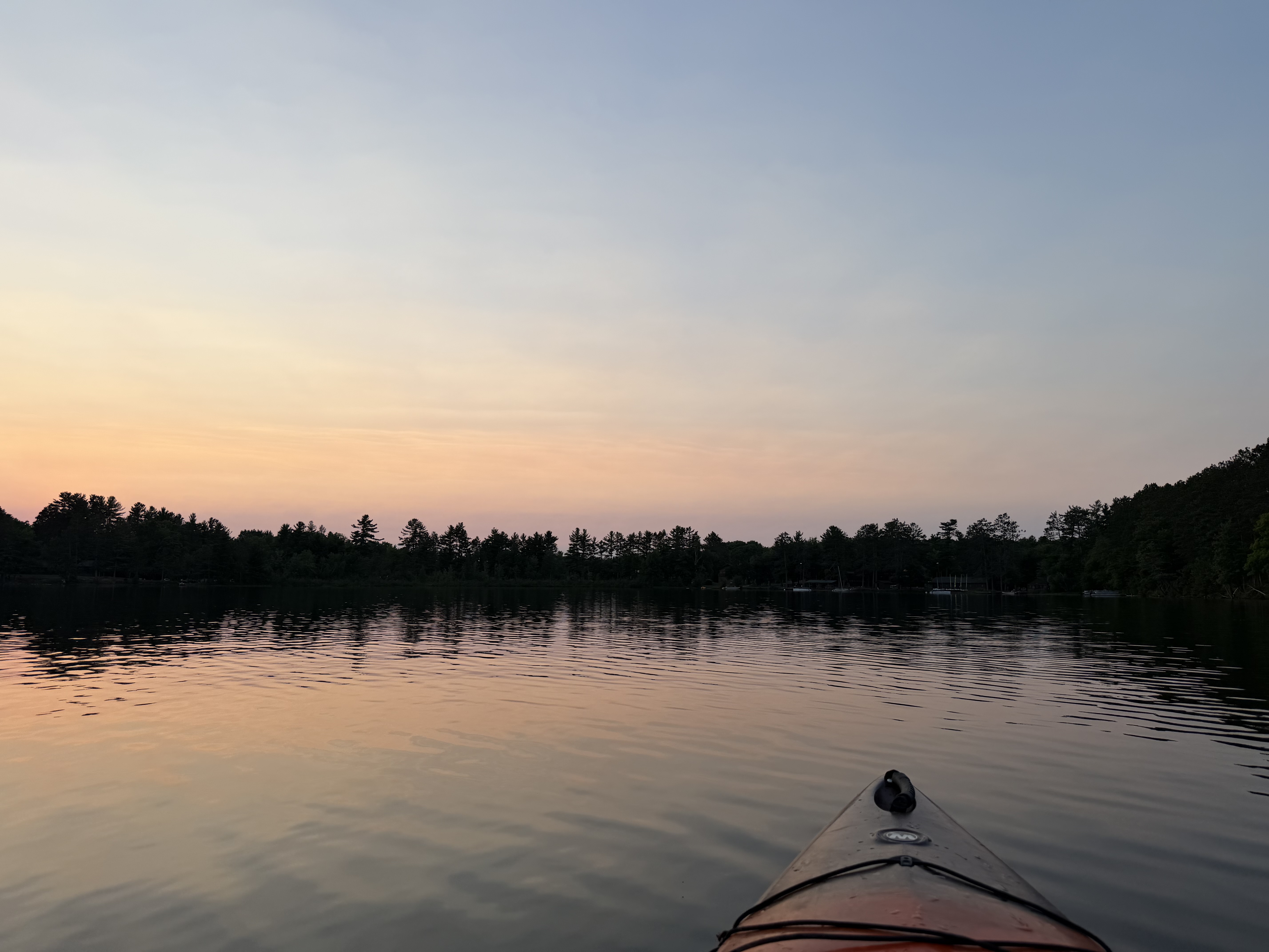A summer sunset settles over the lake in the Wisconsin Northwoods at North Star Camp.