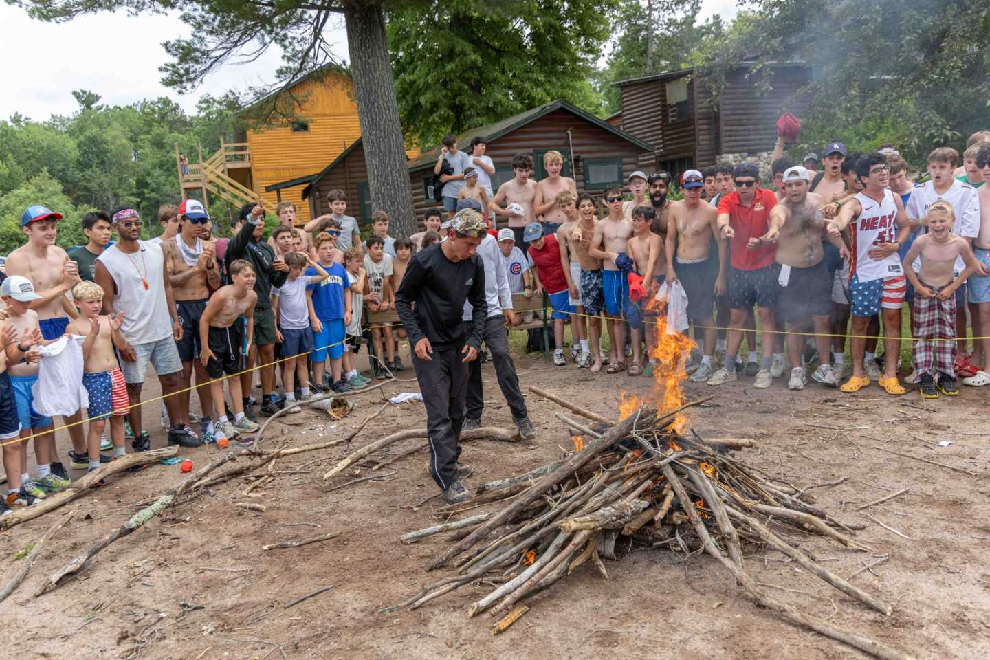 Campers race to build a fire during the Green-White Marathon at a Wisconsin boys summer camp