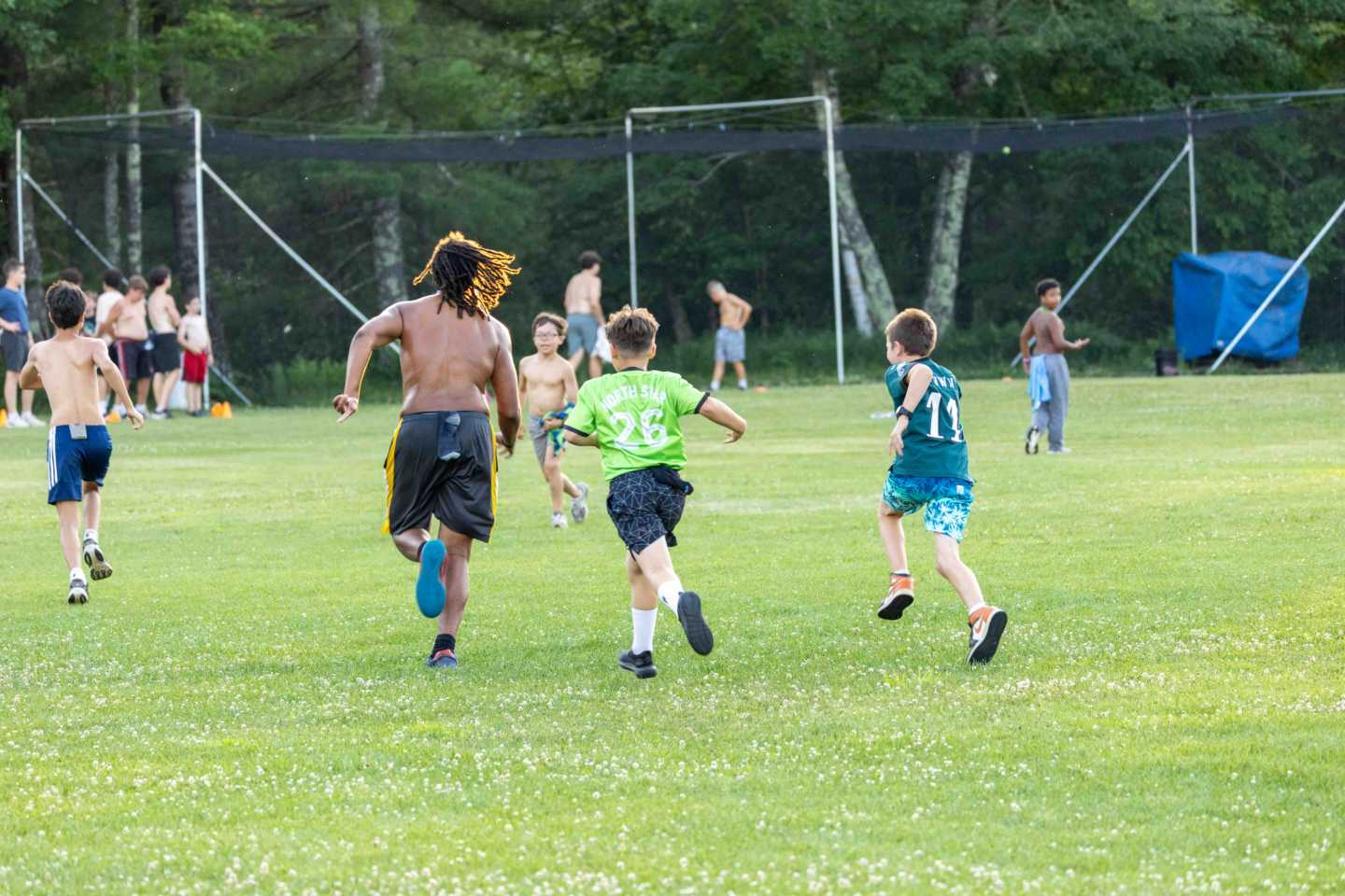 Campers of all ages playing an all-camp game of capture the flag