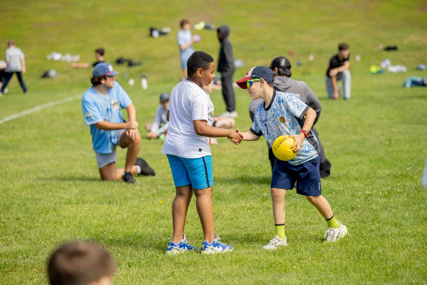 Campers gathered on a field for an all-camp game of continuous dodgeball