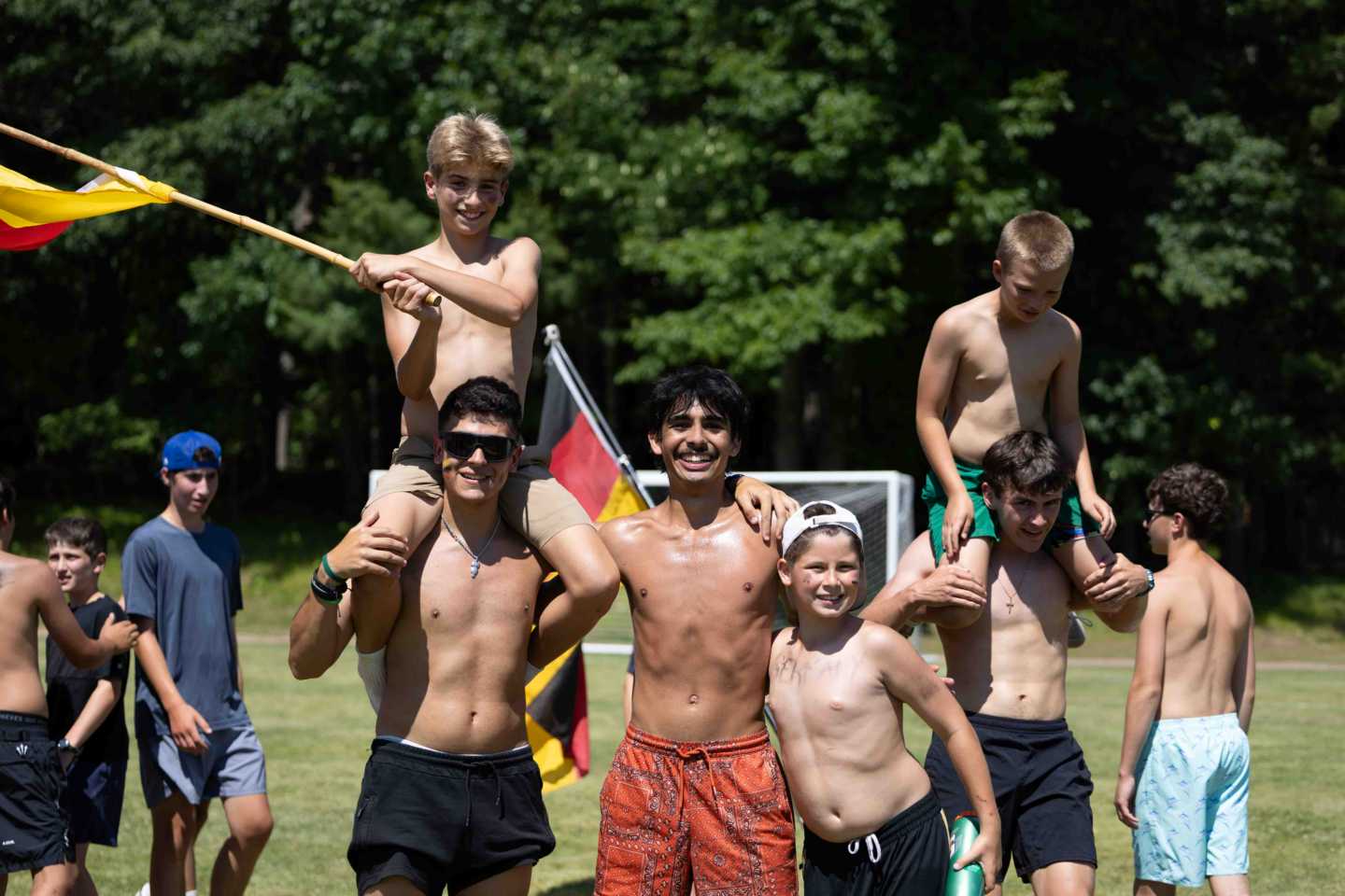A team celebrates with its country flag after United Nations Day at a Wisconsin overnight camp
