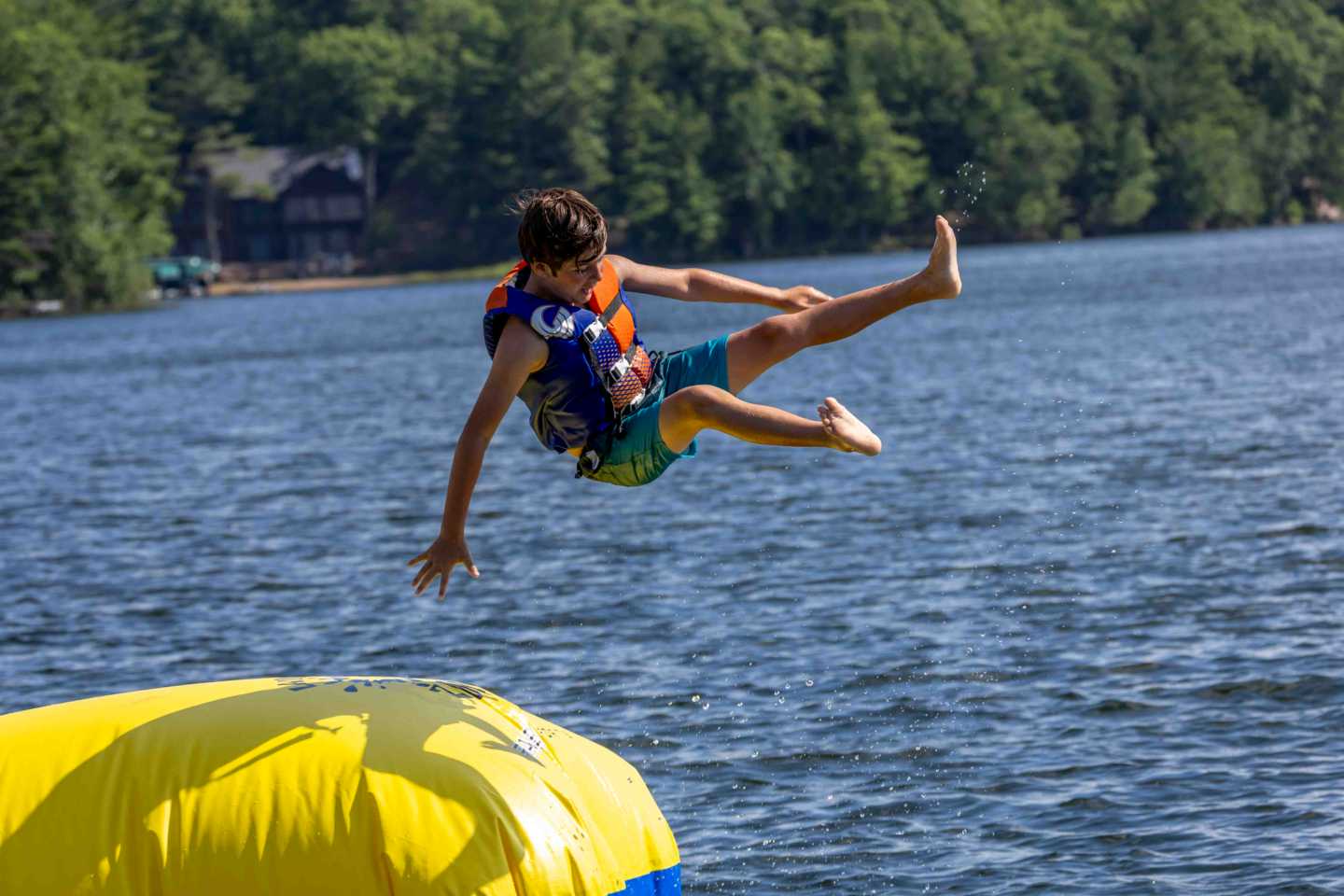 A camper launches into the air off the Blob at the North Star waterfront.